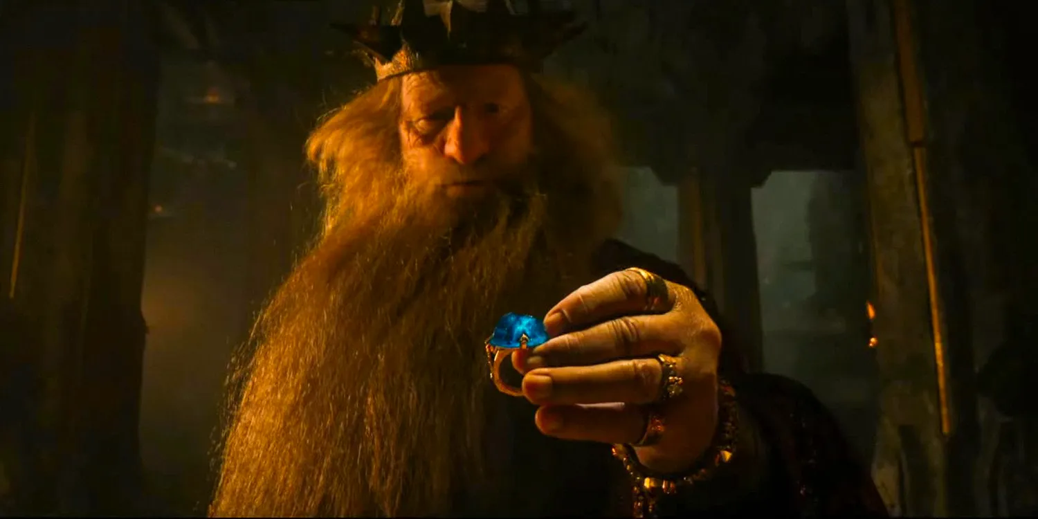 King Durin III holding a ring with an enormous blue stone in The Lord of the Rings: The Rings of Power season 2 Image