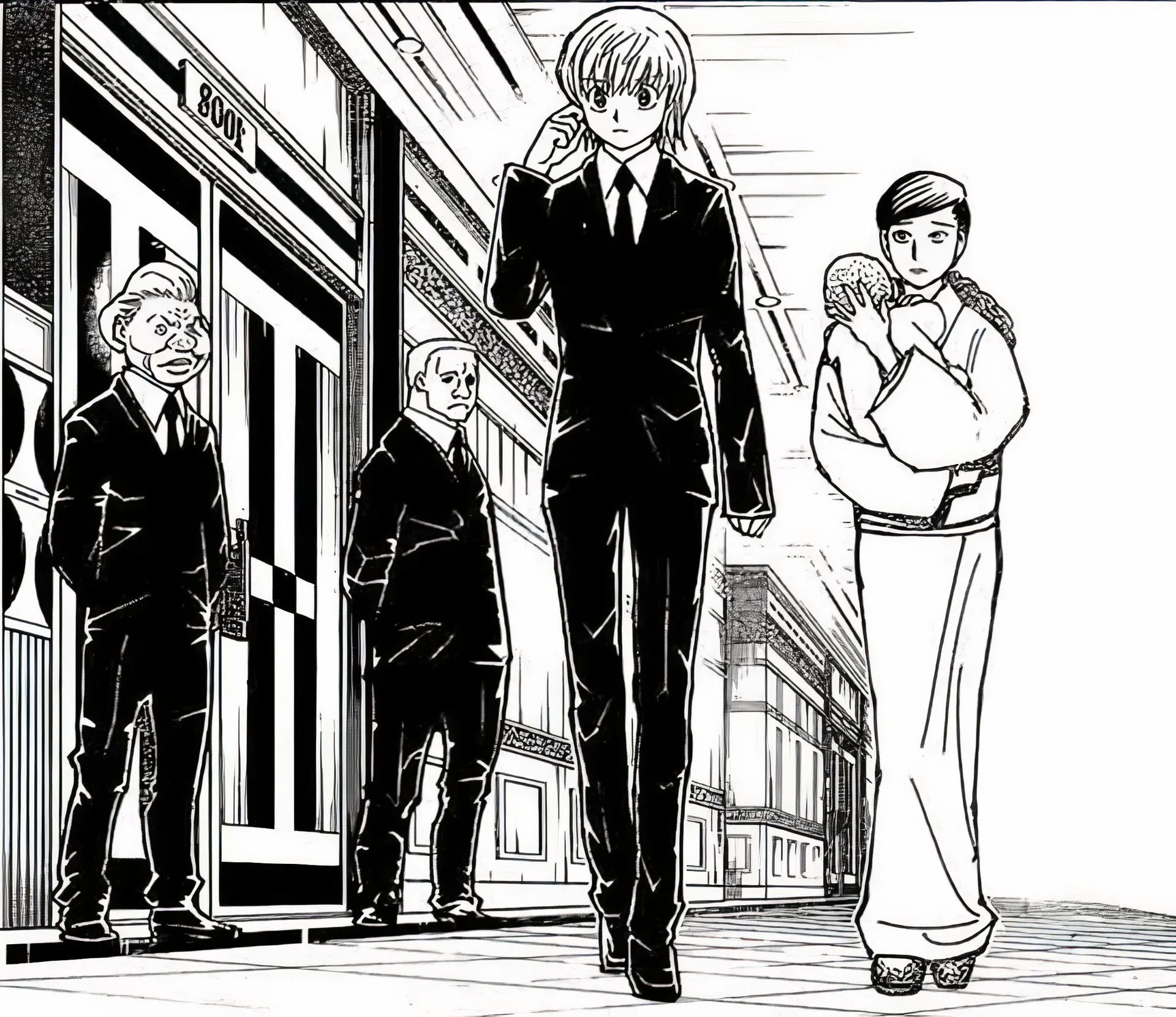 Kurapika in a suit walking away and talking to someone through an ear piece Image