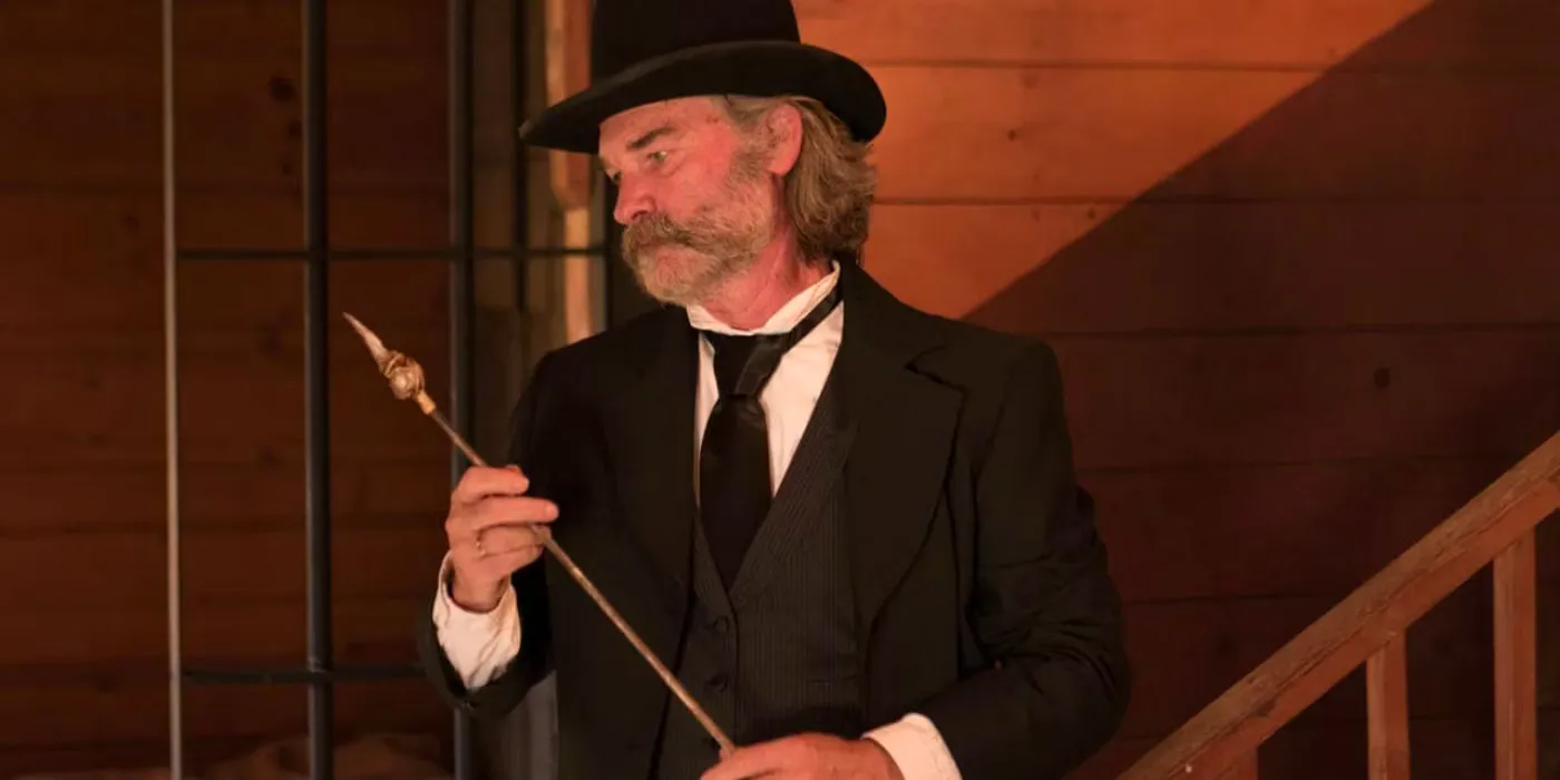 Kurt Russell as Sheriff Franklin inspecting a fire poker in Bone Tomahawk Image