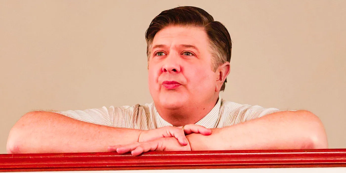 Lance Barber as George Sr. leaning on a railing and staring forward in Young Sheldon Image