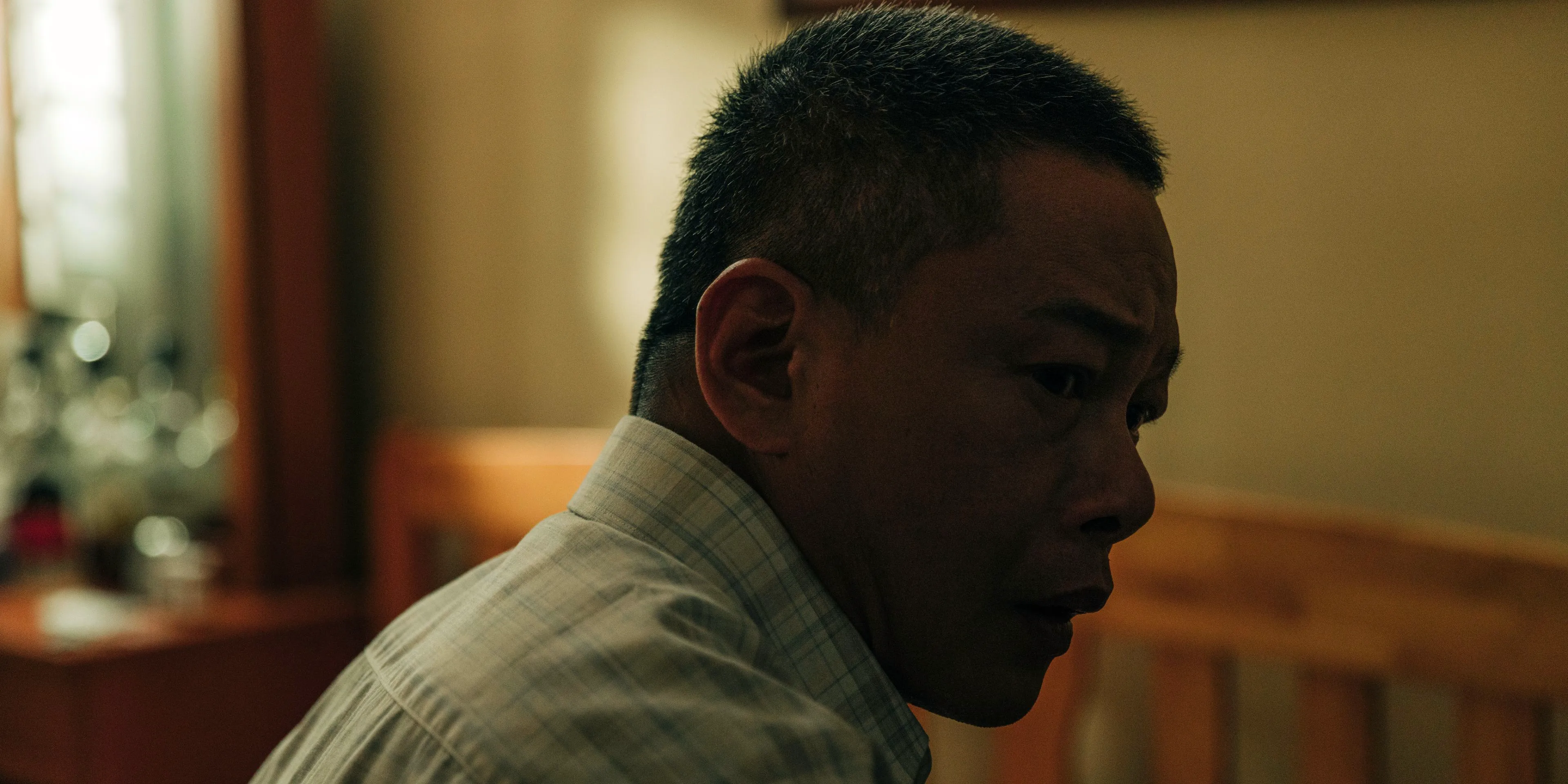 Lao Wu looks over his shoulder in Stranger Eyes Image