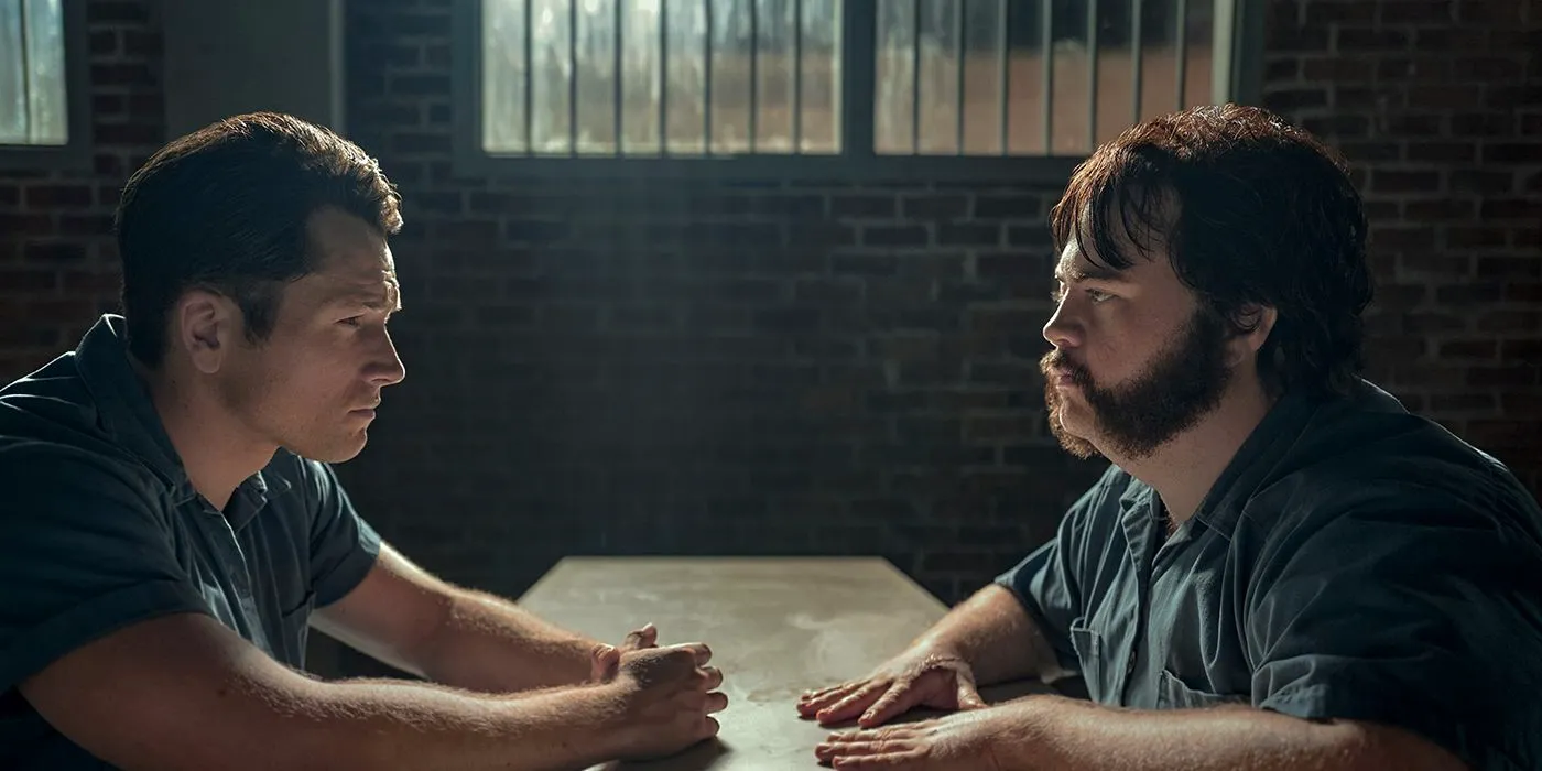 Larry Hill (Paul Walter Hauser) and Jimmy Keene (Taron Egerton) sitting across from one another in prison on Black Bird. Image