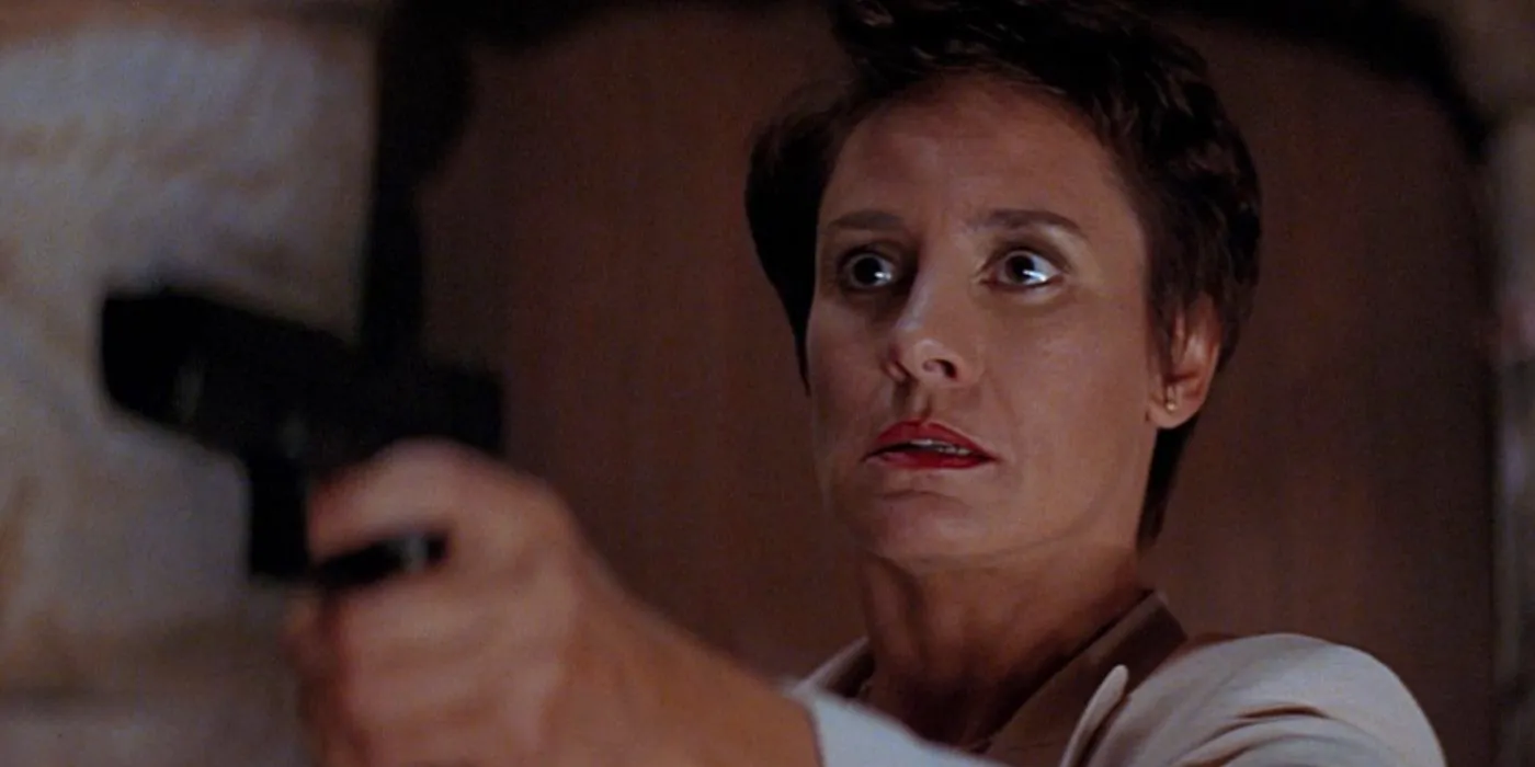 Laurie Metcalf as Nancy Loomis aiming a gun in Scream 2 Image