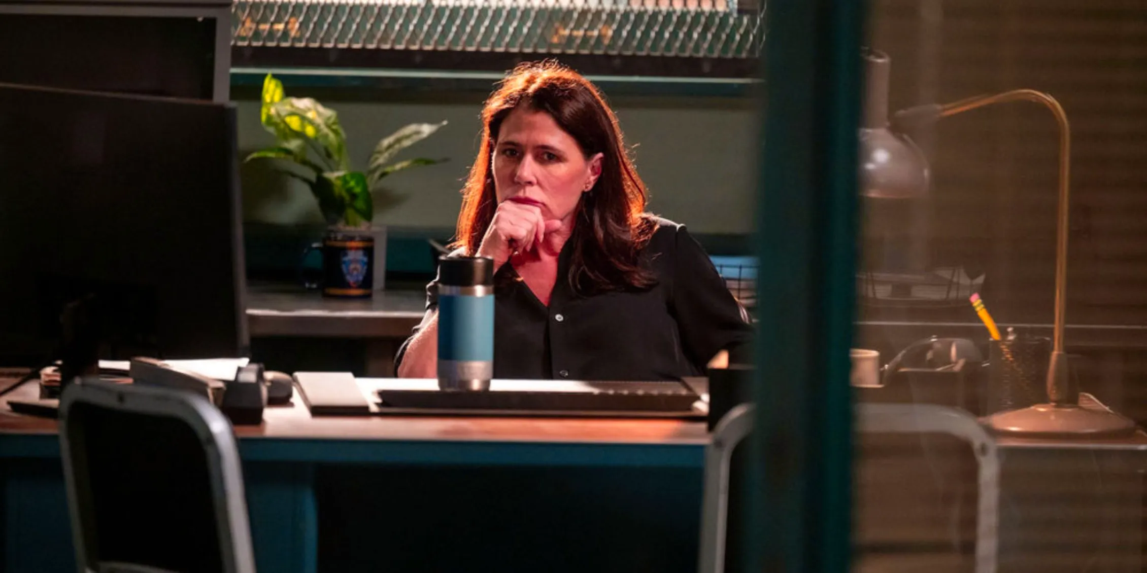 Law & Order: Jessica Brady sitting in the dark at her desk Image