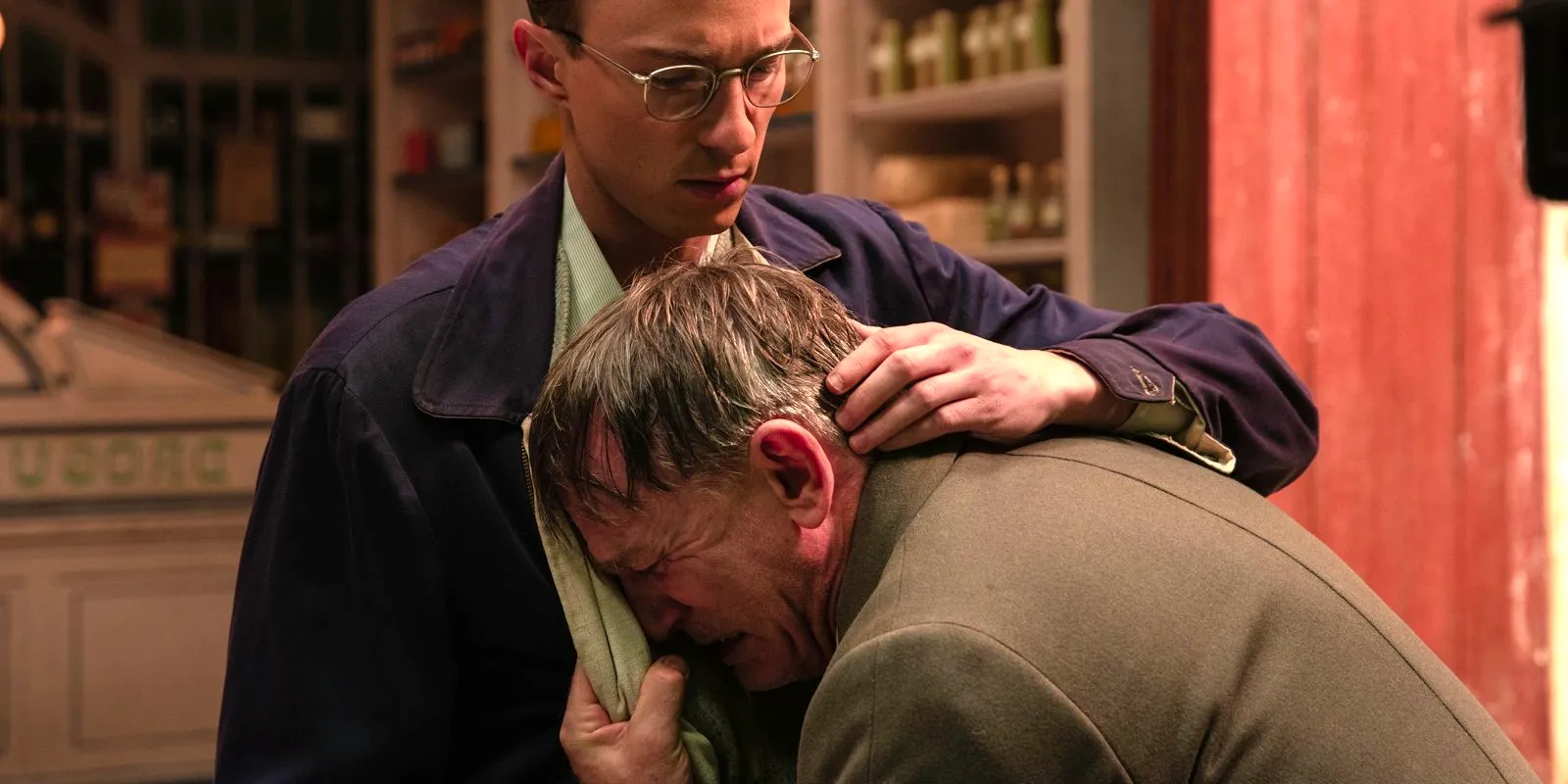 Lee cries into Gene's chest while his hand is on his back in Queer Image