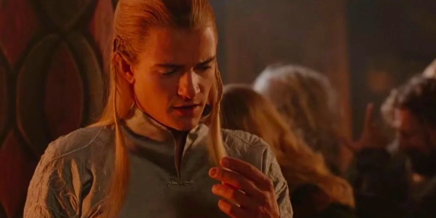 Legolas looking at his fingers during the drinking game in The Lord of the Rings Image