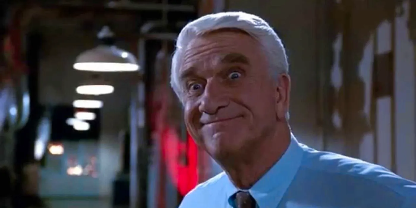 Leslie Nielsen as Frank Drebin making a silly face in The Naked Gun 2 1/2: The Smell of Fear Image