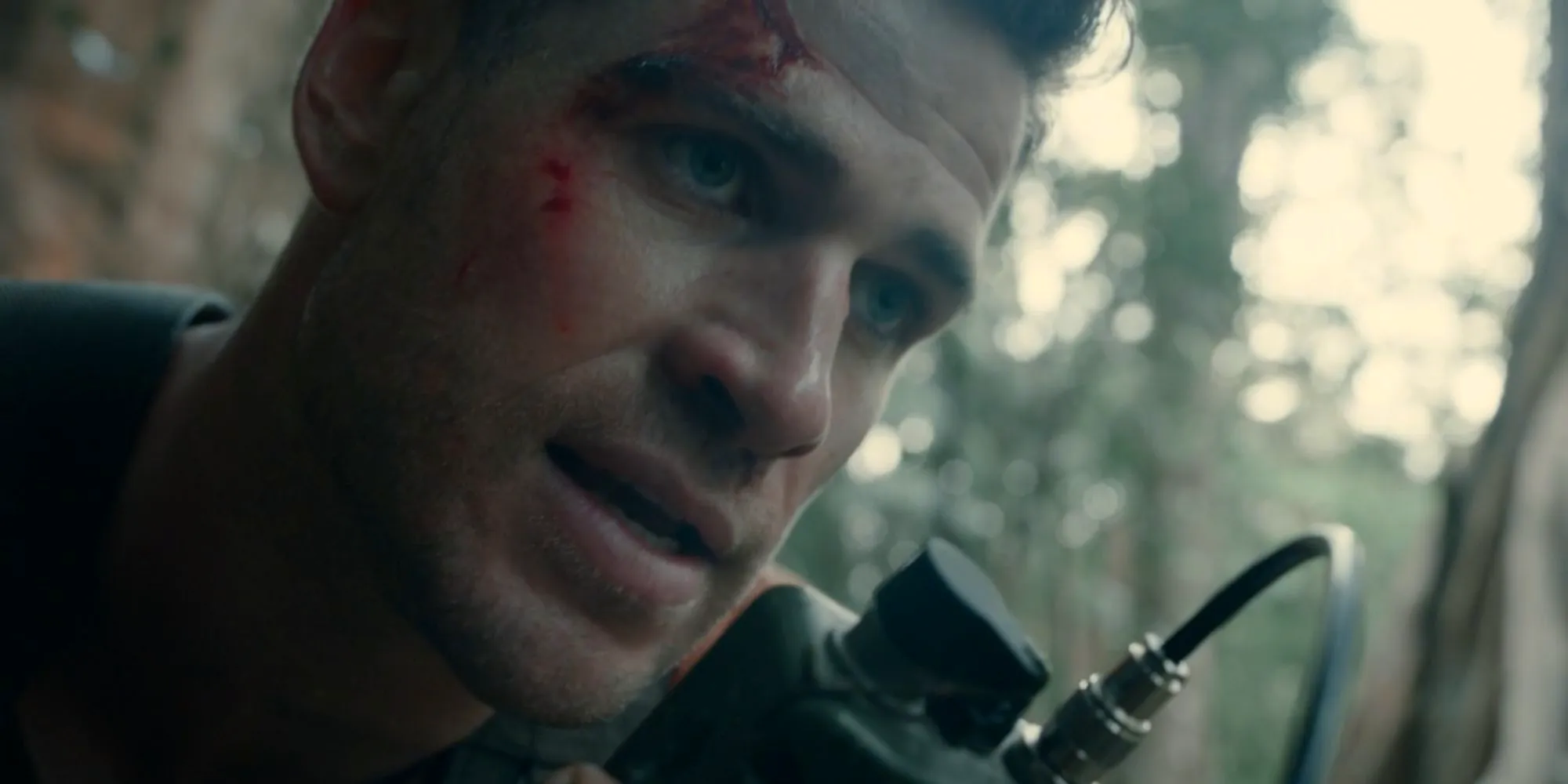 Liam Hemsworth as Sgt. Kinney speaking on a walkie-talkie in Land of Bad Image