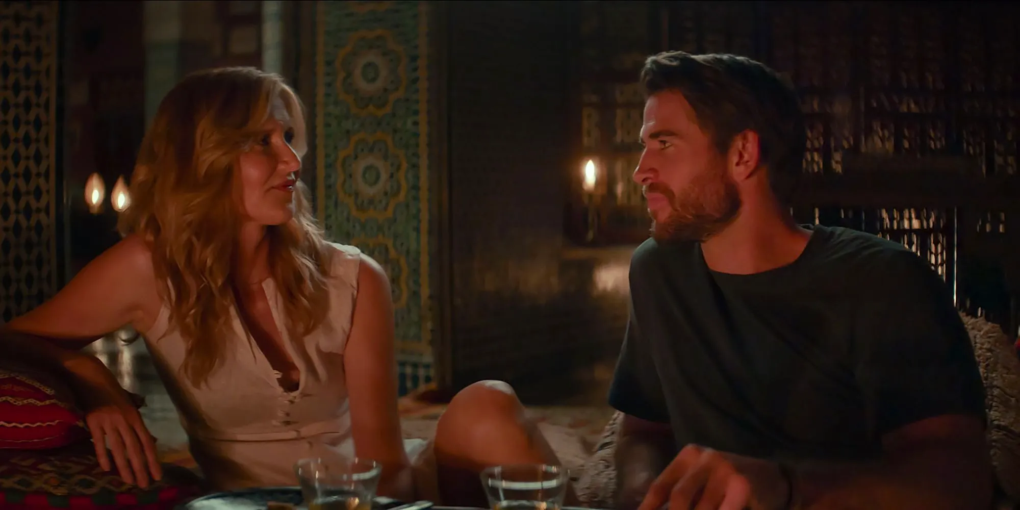 Liam Hemsworth & Laura Dern talking in the room in Lonely Planet Image