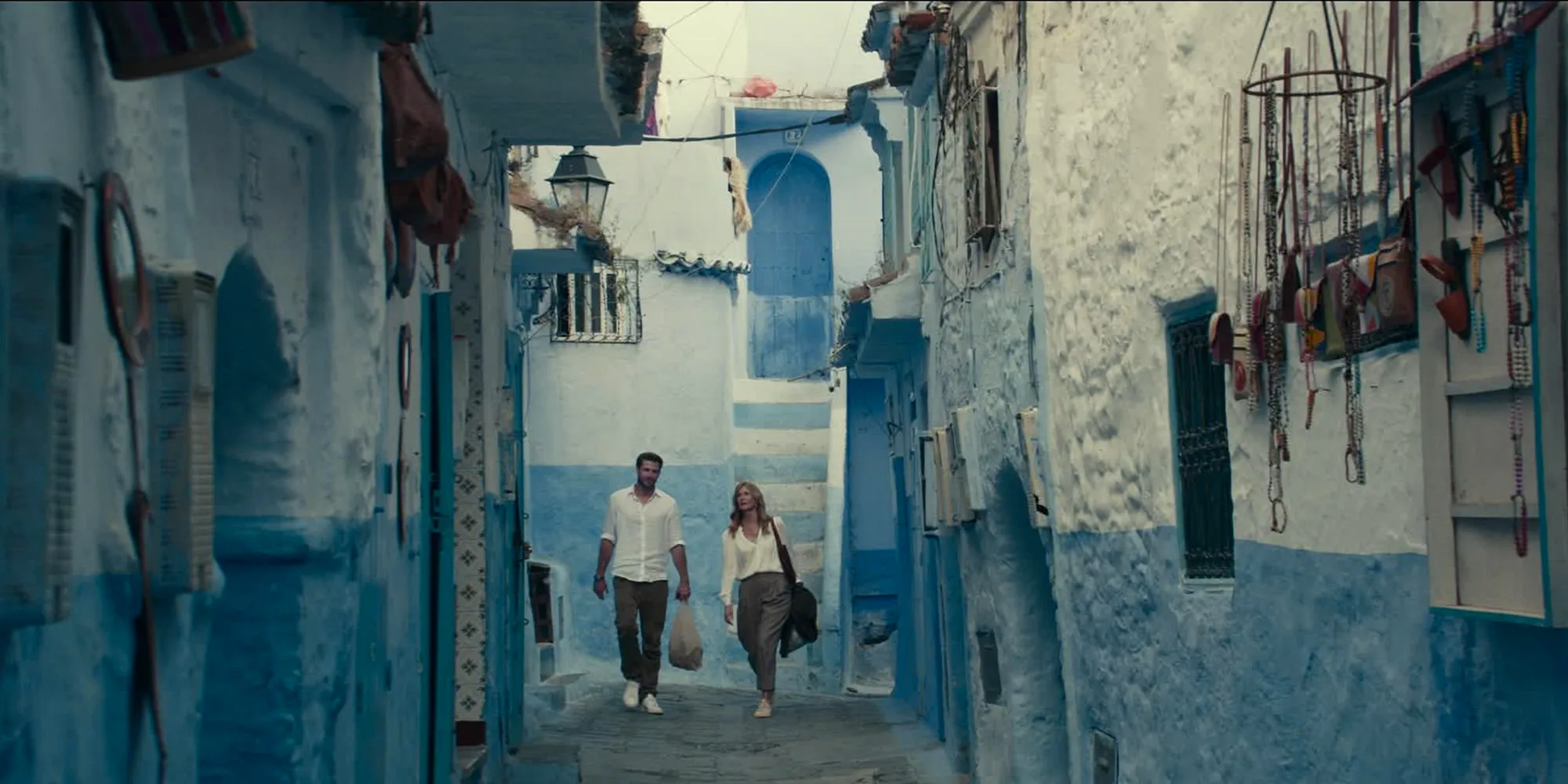 Liam Hemsworth & Laura Dern walking down the streets of Morocco in Lonely Planet Image