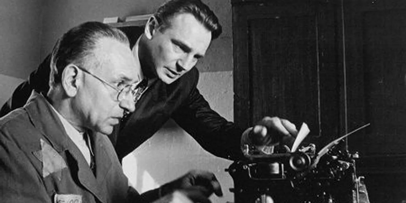 Liam Neeson and Ben Kingsley at a typewriter in Schindler's List. Image