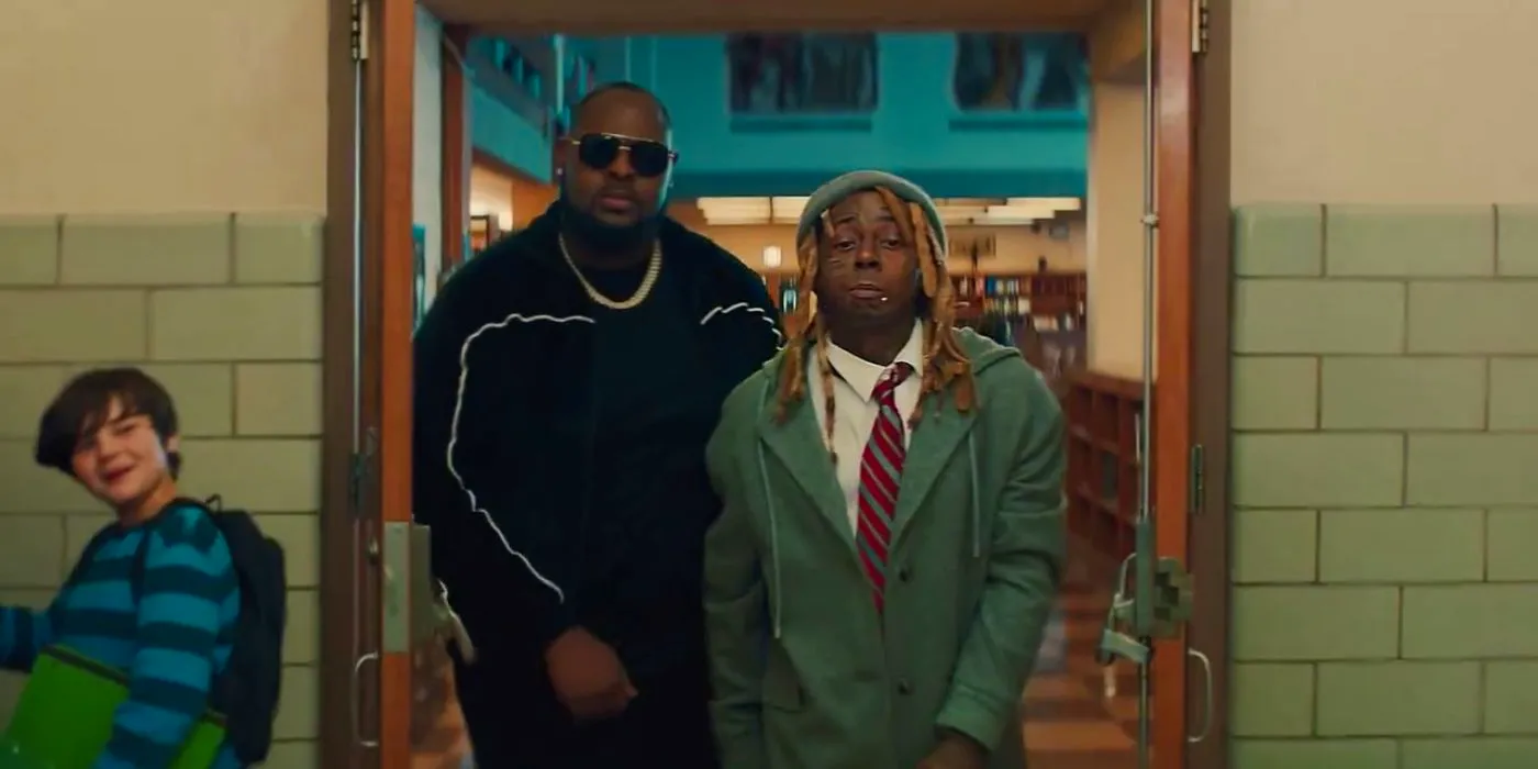 Lil Wayne walking into a school flanked by a bodyguard in a Homes.com commercial. Image