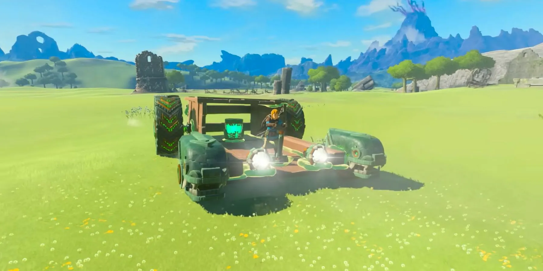 Link driving a car built with Ultrahand through a field in Tears of the Kingdom. Image