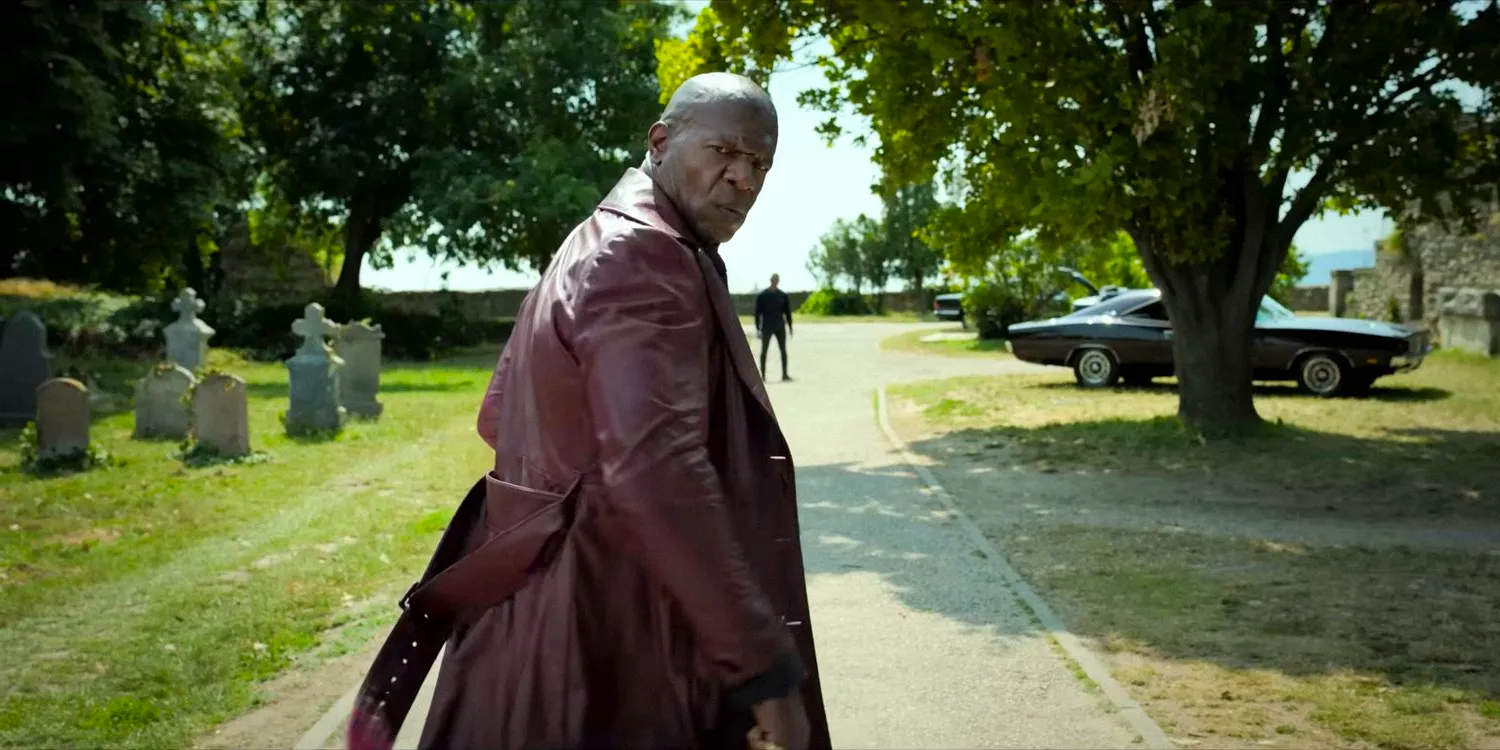 Lovedahl (Terry Crews) looking at his back in The Killer's Game (2024) Image