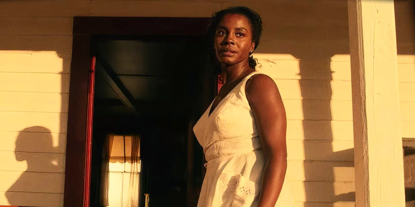 Lucky Emory (Deborah Ayorinde) looking frightened on her porch in Them Covenant. Image