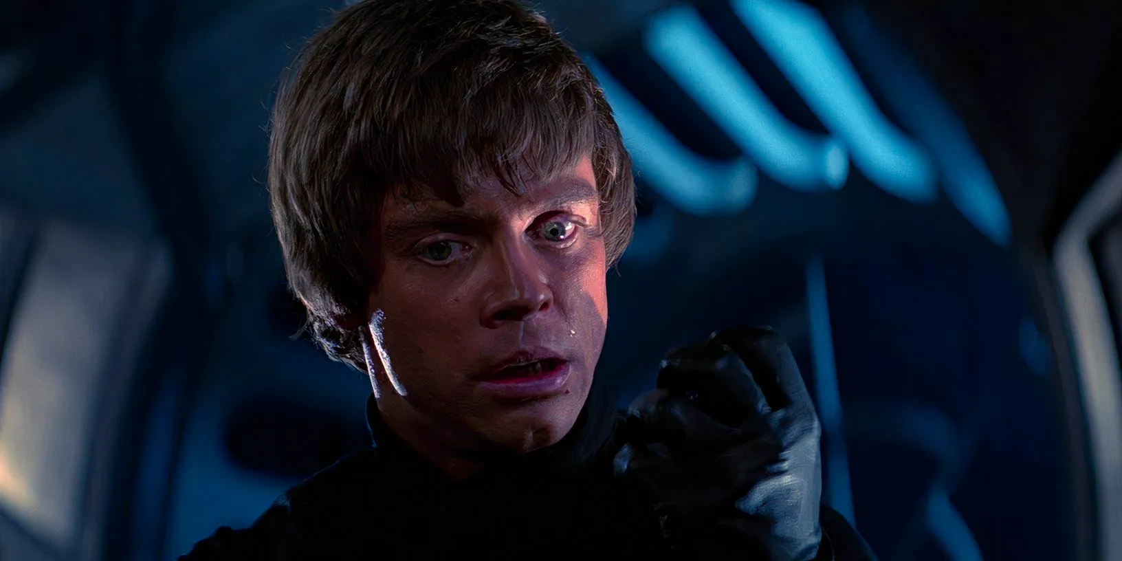 Luke Skywalker (Mark Hamill) looks down at his clenched fist while standing over a defeated Darth Vader in Return of the Jedi Image