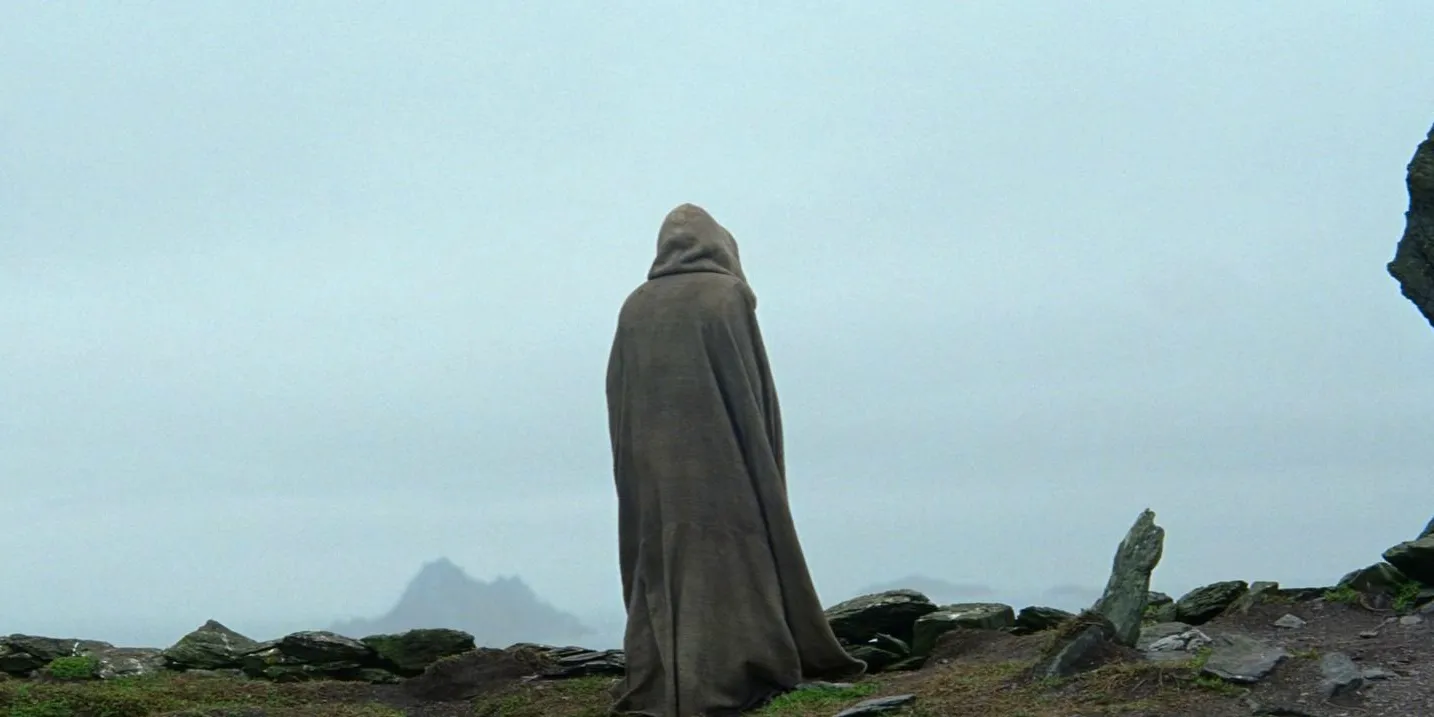 Luke Skywalker standing by something that looks like a grave in The Force Awakens Image