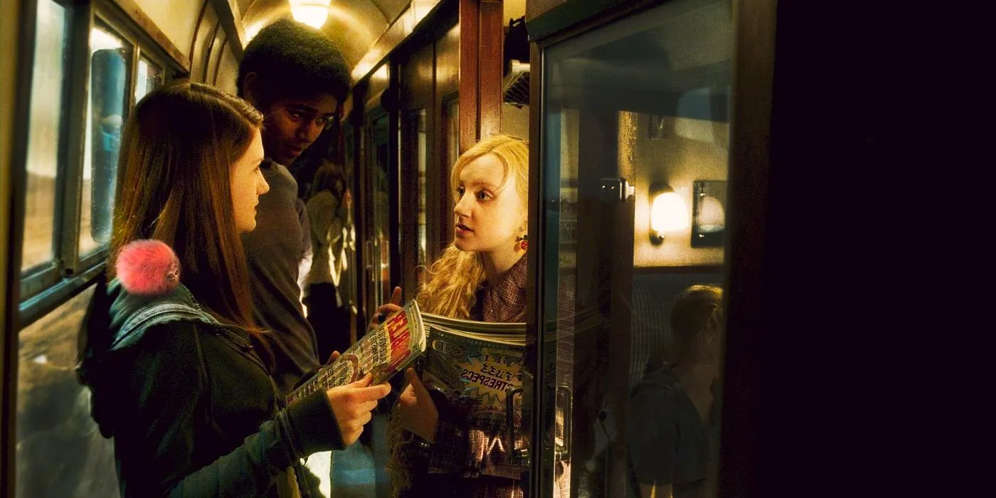 Luna Lovegood, Ginny Weasley, and Dean Thomas talking in the train in one of the Harry Potter movies Image