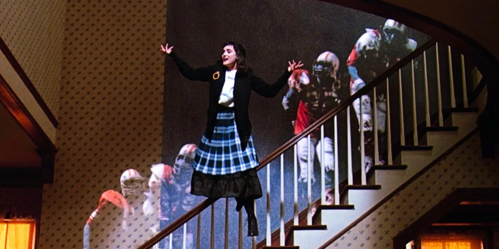 Lydia dancing with the football players in Beetlejuice's ending Image