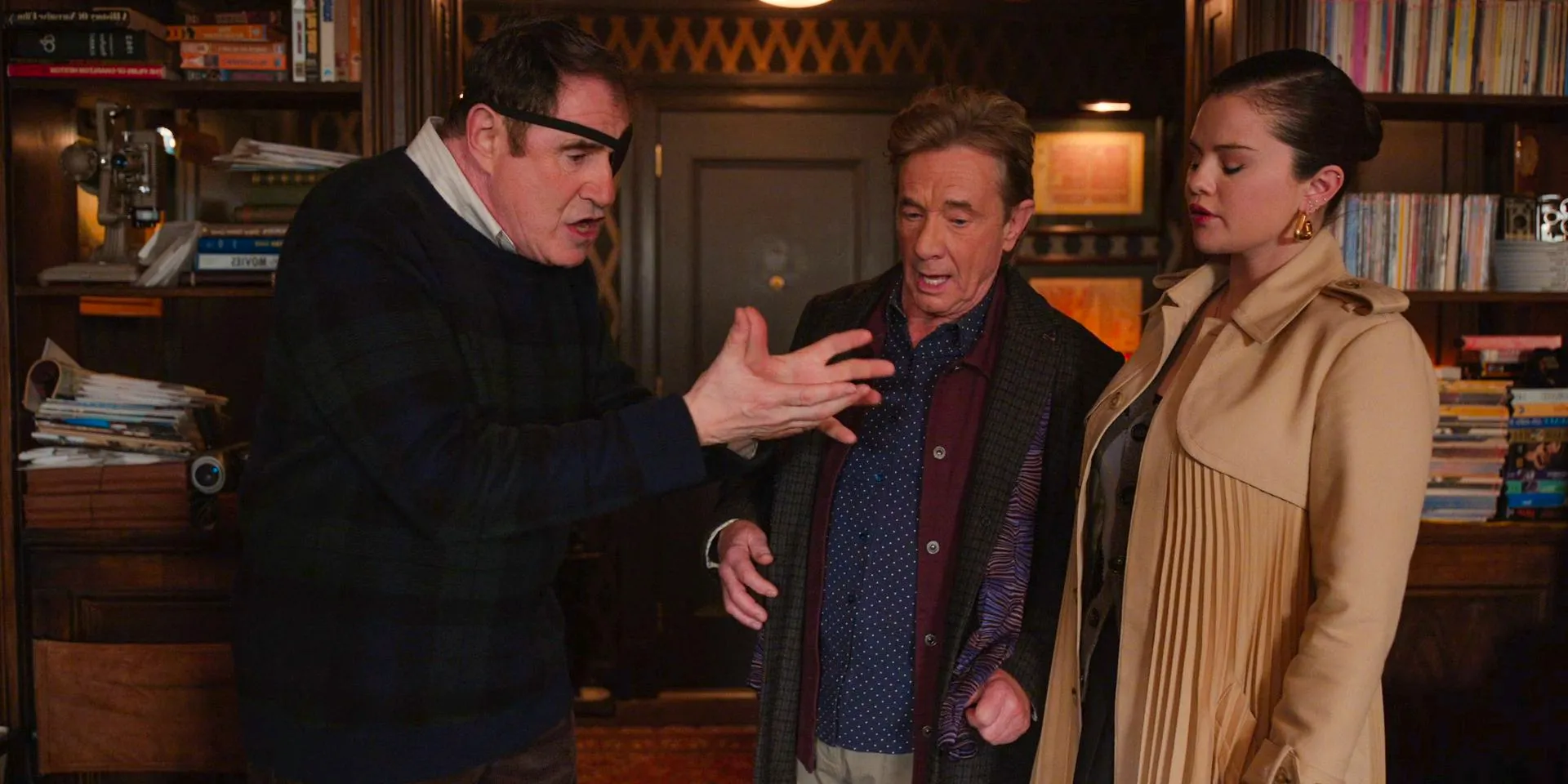 Mabel (Selena Gomez) and Oliver (Martin Short) visit Vince Fish's (Richard Kind) apartment in search of clues in Only Murders in the Building Season 4 Episode 2 Image