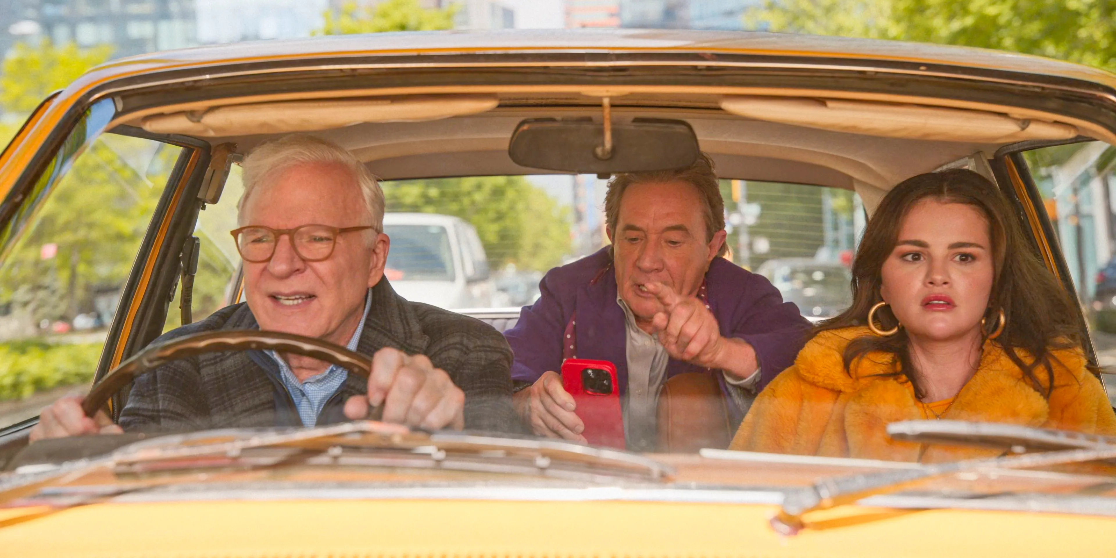 Mabel (Selena Gomez), Oliver (Martin Short) and Charles (Steve Martin) fleeing from their building in Only Murders in the Building Season 4 Episode 7 Image