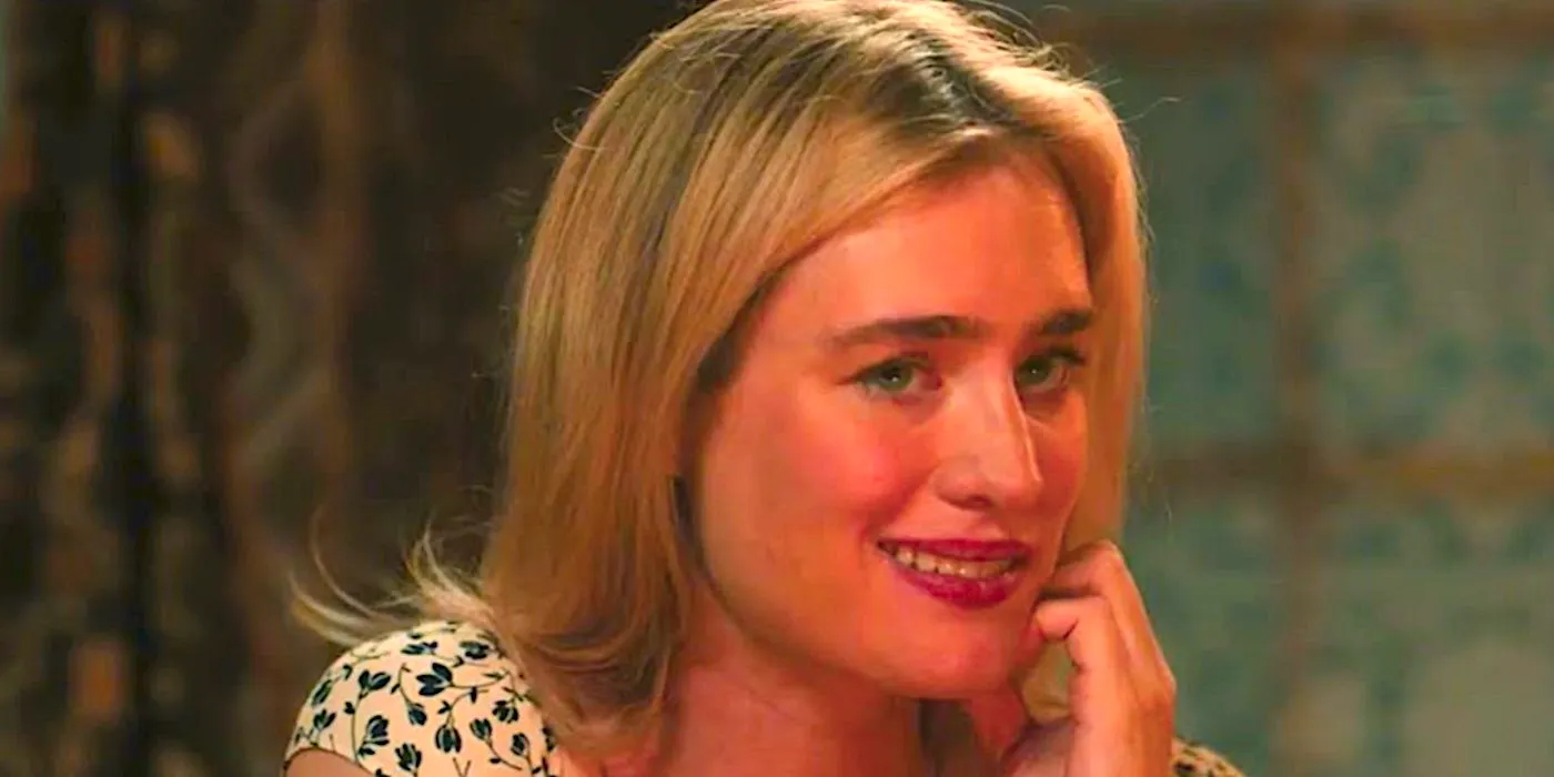 MacKenzie Davis' Louise smiles nervously at the dinner table in Speak No Evil 2024 Image