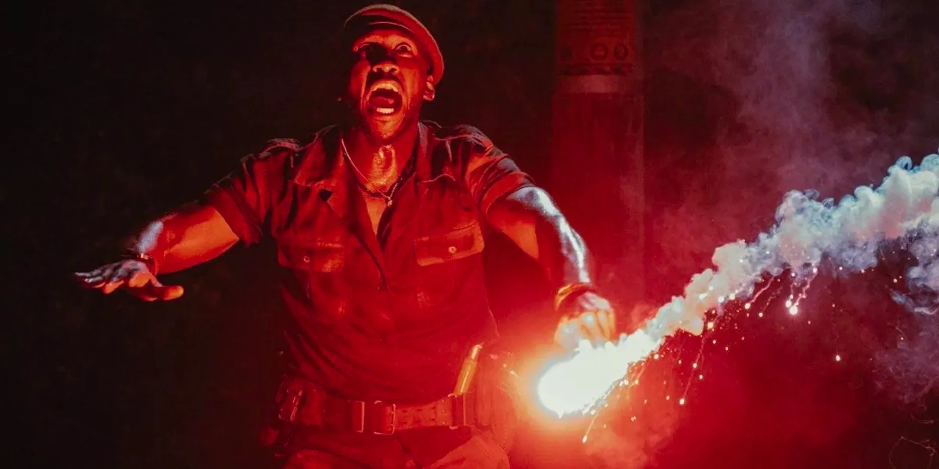 Mahershala Ali looking scared with a flare in Jurassic World Rebirth Image