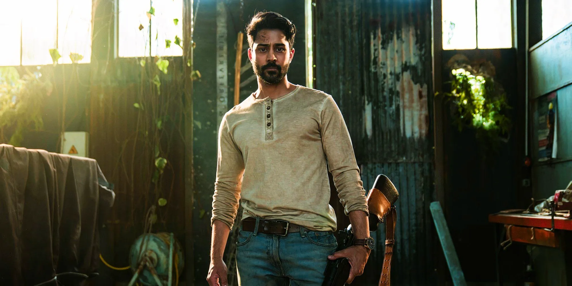 Manish Dayal as Ash holding a gun in The Walking Dead Daryl Dixon season 2 Image