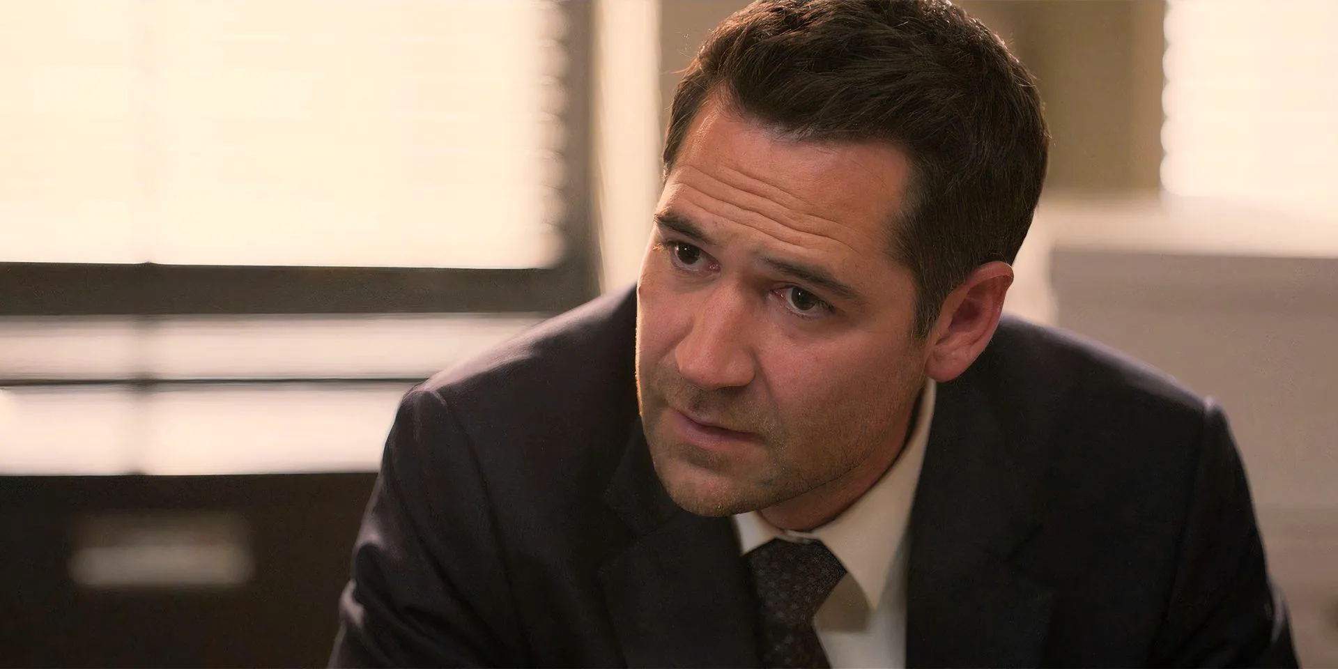 Manuel Garcia-Rulfo in The Lincoln Lawyer season 2, episode 4, looking annoyed as Mickey Image