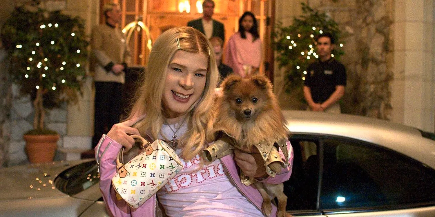 Marcus holding up his dog and bag in White Chicks. Image