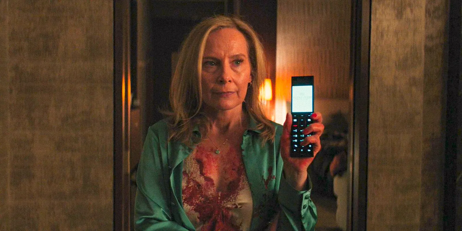 Margaret (Amy Ryan) holding a phone in WOLFS Image