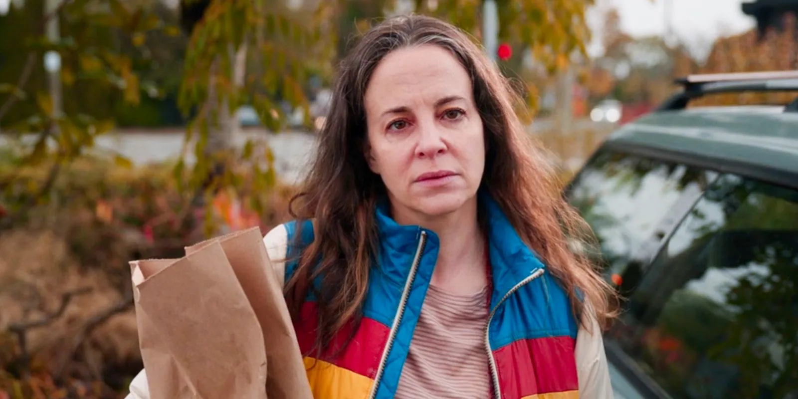 Maria Dizzia as Sandra Nears looking tired while carrying a bag in School Spirits Image