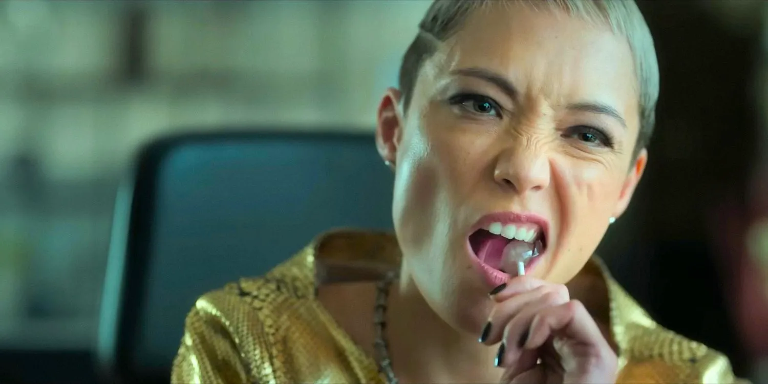 Marianna (Pom Klementieff) biting into a lollipop in The Killer's Game (2024) Image