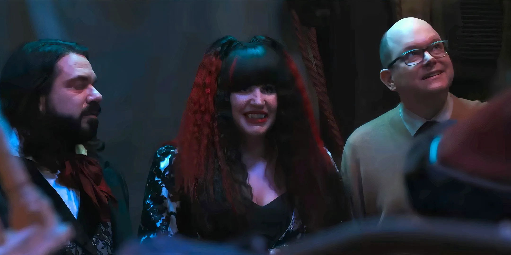 Mark Proksch's Colin Robinson and Natasia Demetriou's Nadja looking happy as Jerry wakes up in What We Do in the Shadows season 6 Image