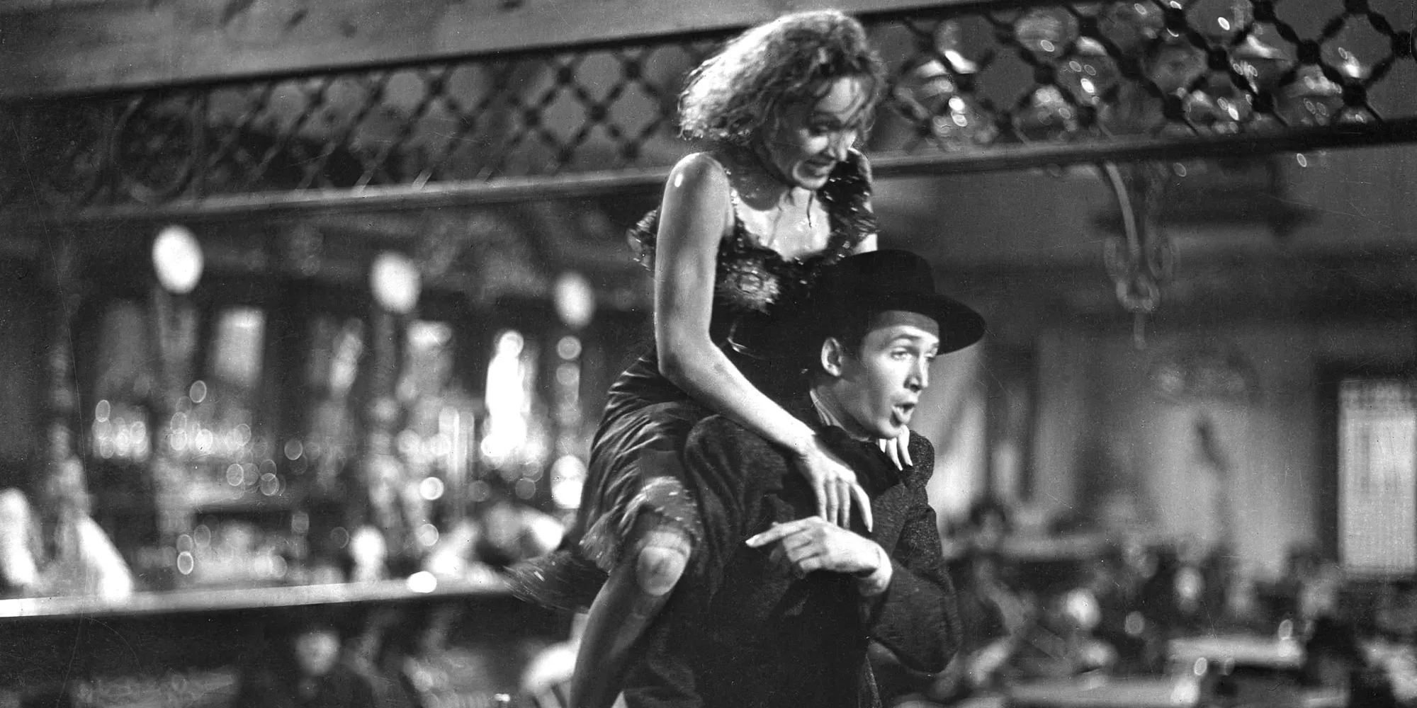 Marlene Dietrich on Jimmy Stewart's back in Destry Rides Again Image