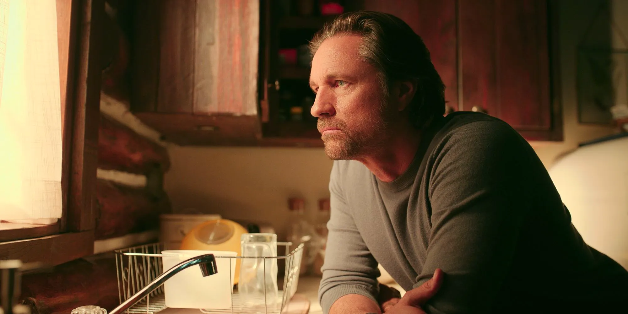 Martin Henderson in Virgin River season 5 looking out a window Image