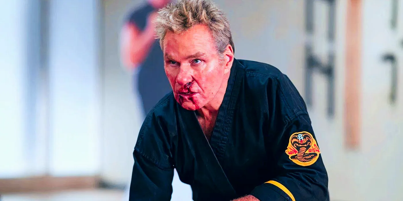 Martin Kove as John Kreese in Cobra Kai kneeling with blood on his face Image