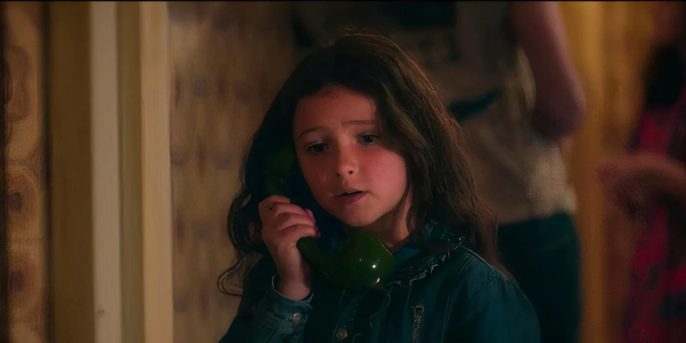 Matilda Firth talks on the phone with a worried expression in Wolf Man Image