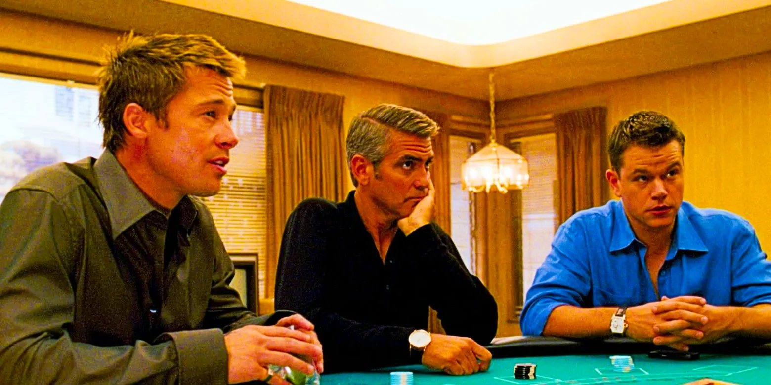 Matt Damon as Linus Brad Pitt as Rusty and George Clooney as Danny sitting at card table in Ocean's Thirteen Image