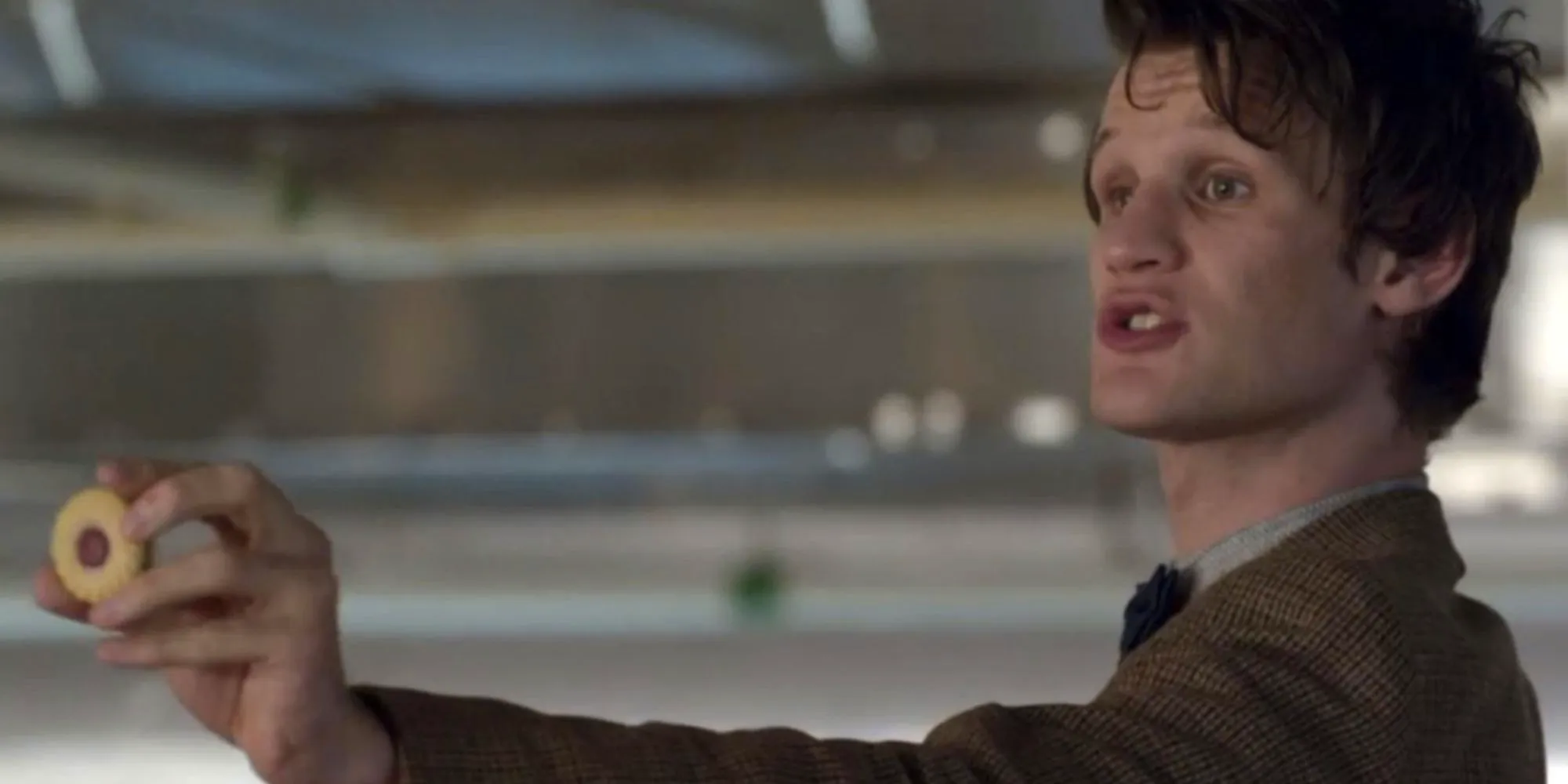 Matt Smith's Eleventh Doctor holding out a Jammie Dodger in Doctor Who Image