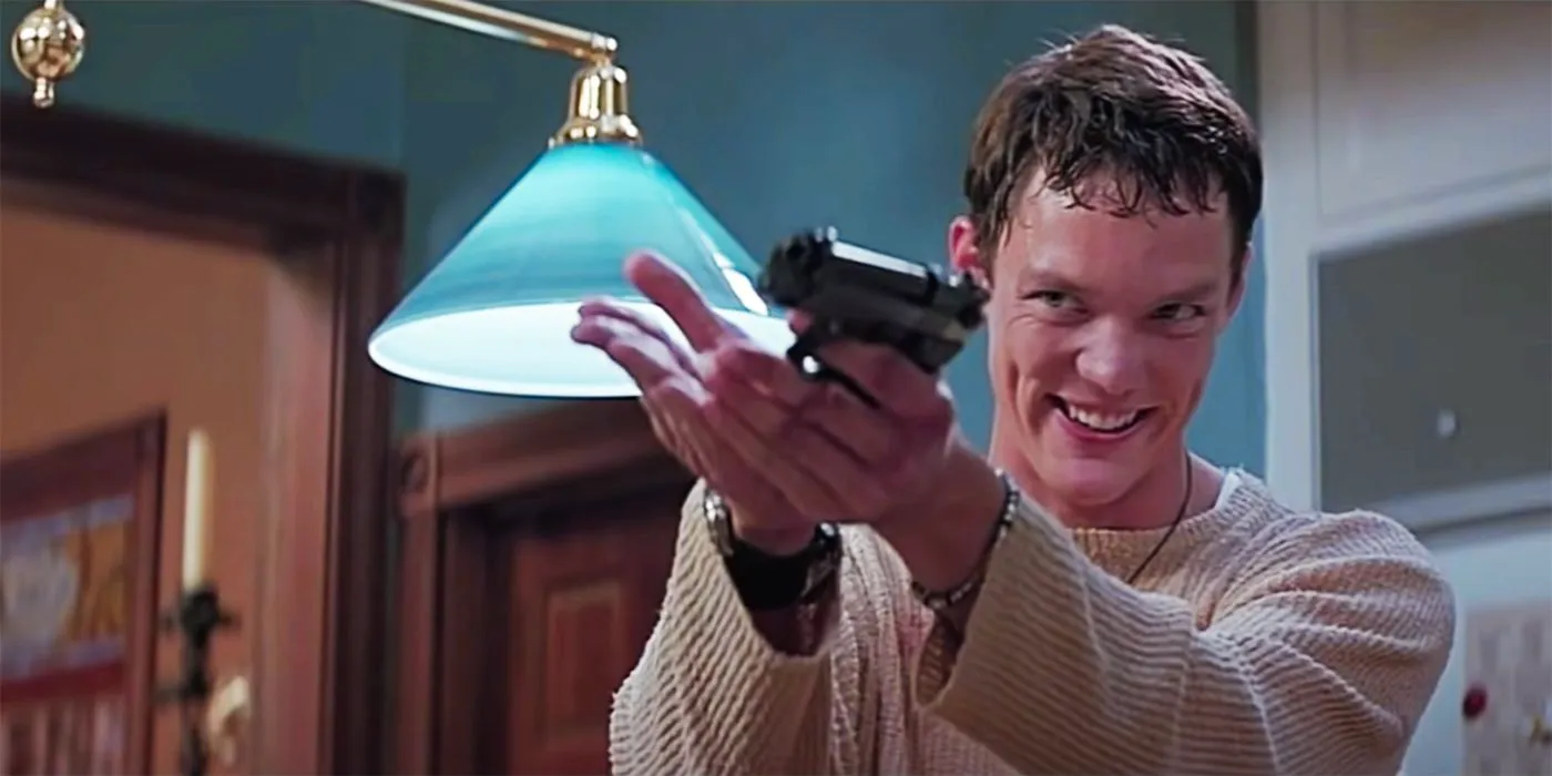 Matthew Lillard as Stu Macher smiling and holding up a gun in Scream Image