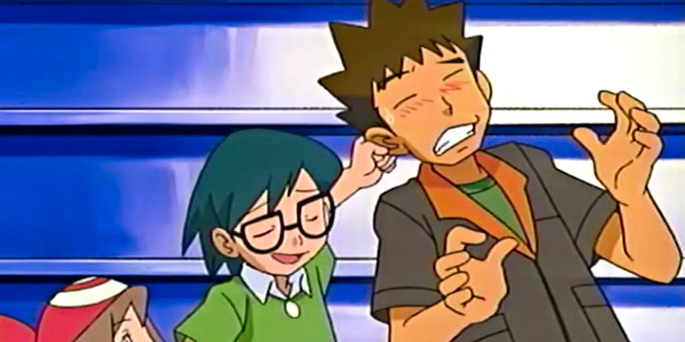 Max grabs Brock's ear to drag him away from a female character. Image