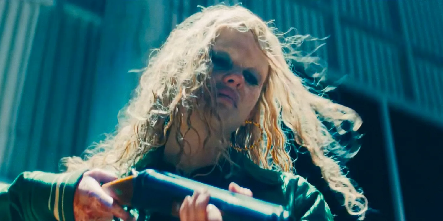 Maxine (Mia Goth) with smudged makeup pointing a gun in MaXXXine (2024)  Image