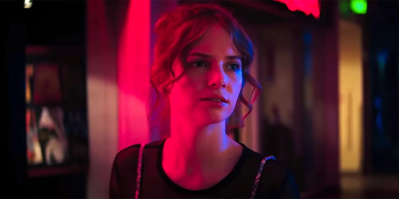 Maya Hawke as Heather in a red-lit mall in Fear Street Part One: 1994 Image