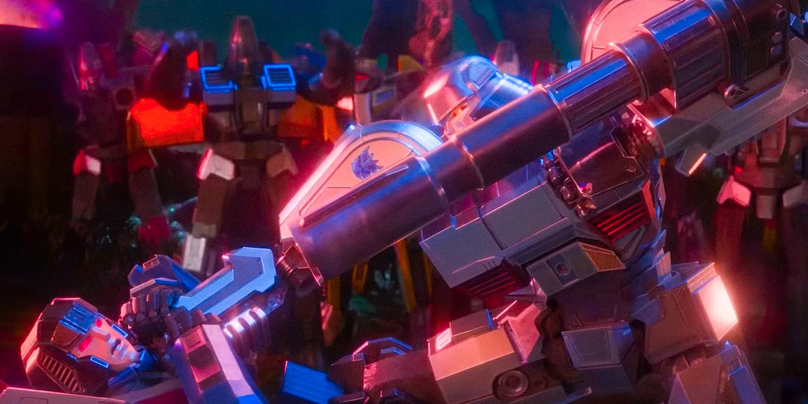 Megatron (Brian Tyree Henry) threatening Orion Pax (Chris Hemsworth) with a weapon in Transformers One Image