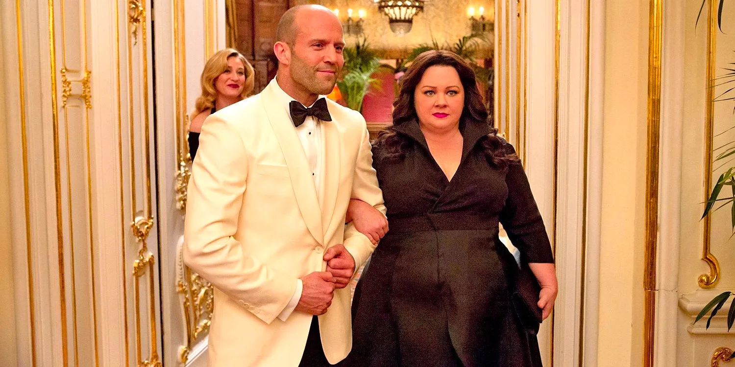 Melissa McCarthy linking arms with Jason Statham in Spy Image