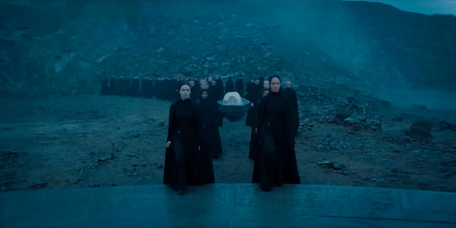 Members of the Bene Gesserit Sisterhood carrying a body during a procession in Dune Prophecy Image