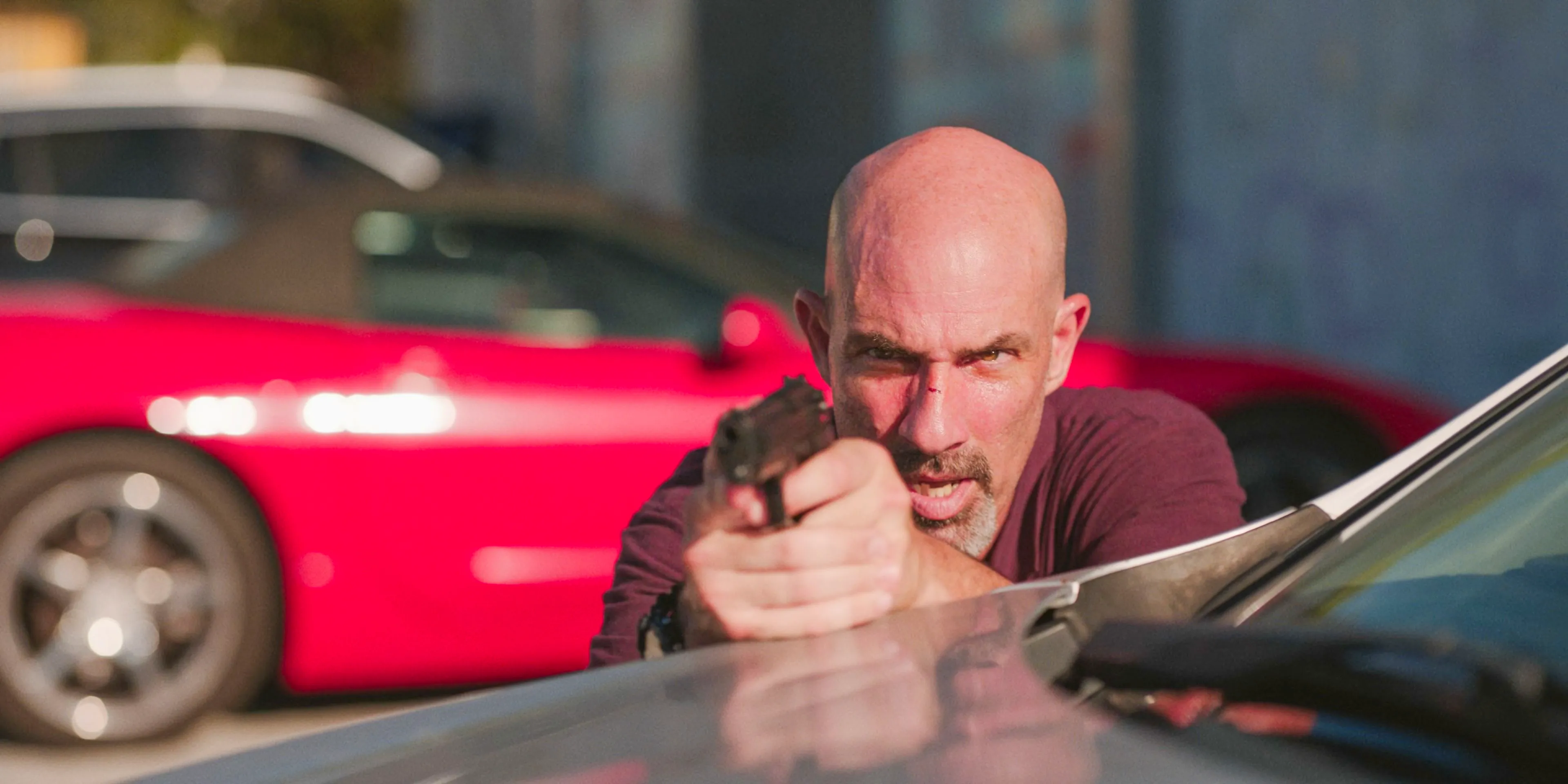 Mendez (Gonzalo Menendez) pointing a gun at Yancy in Bad Monkey Season 1 Episode 7 Image