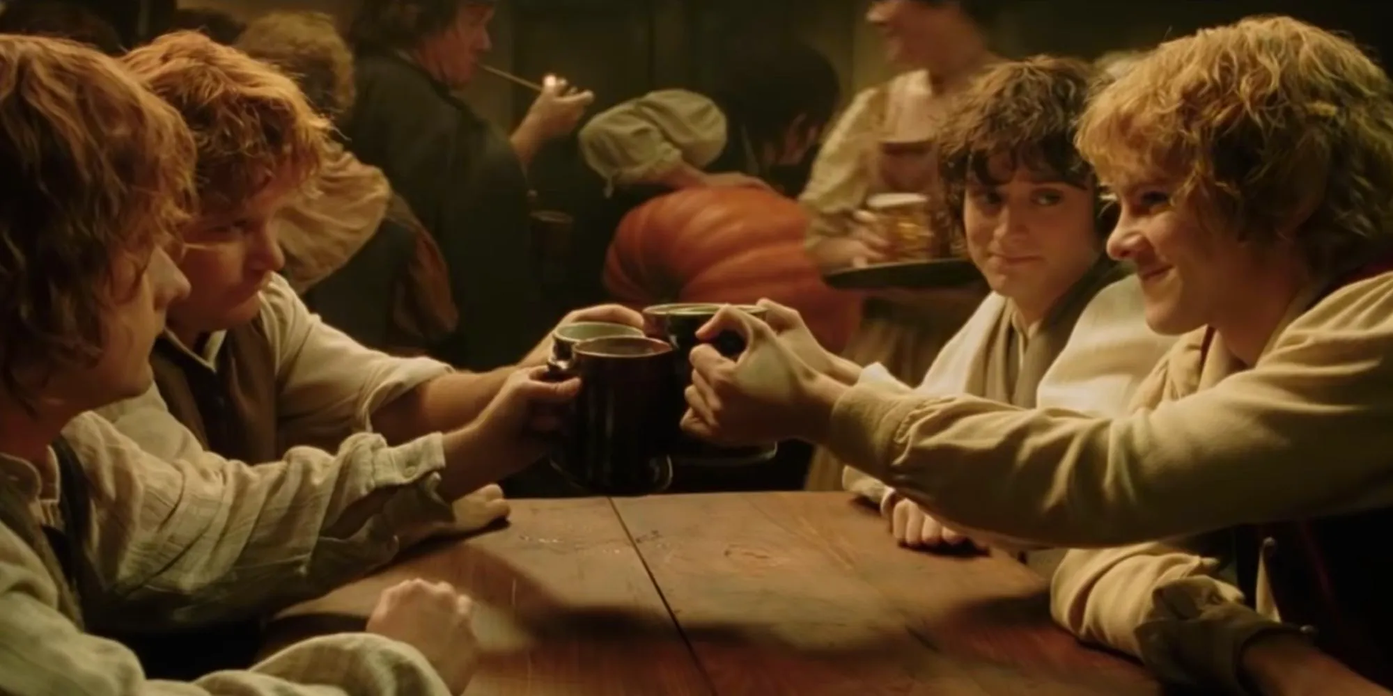 Merry Sam Pippin and Frodo cheers beer glasses at the Green Dragon at the end of Lord of the Rings: The Return of the King. Image