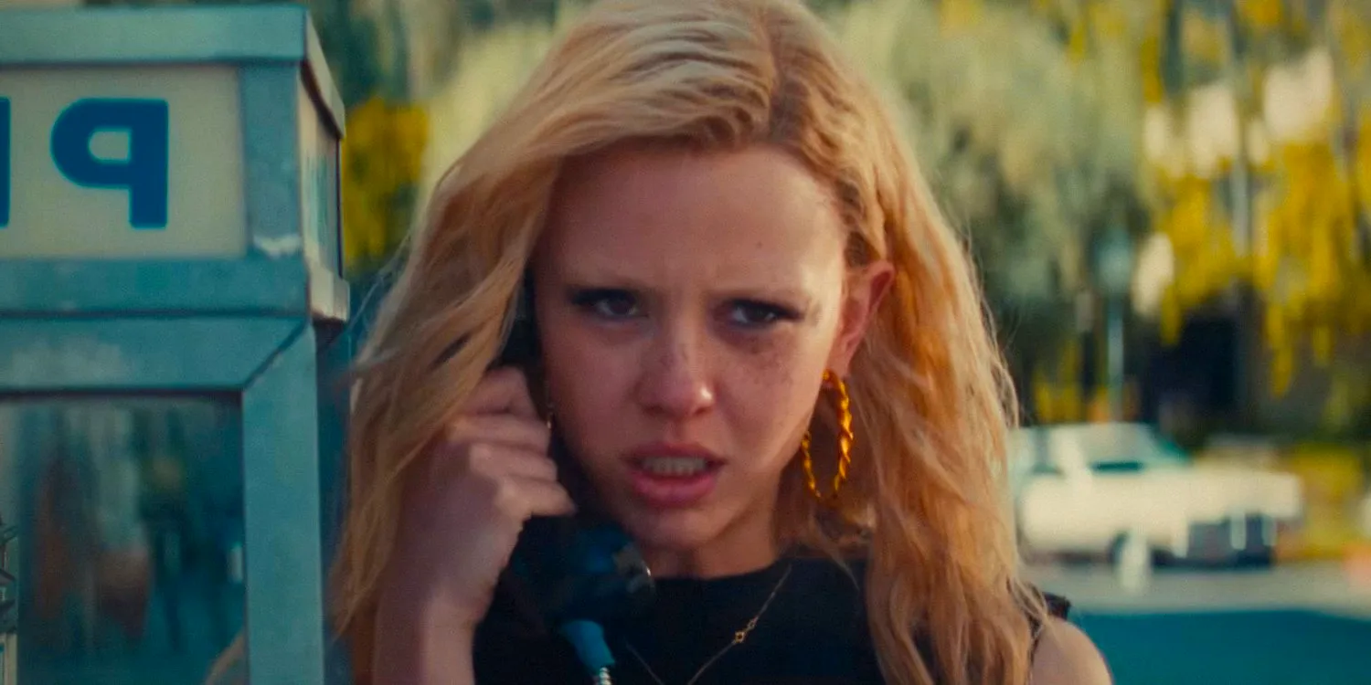 Mia Goth as Maxine making a phone call from a payphone in MaXXXine Image